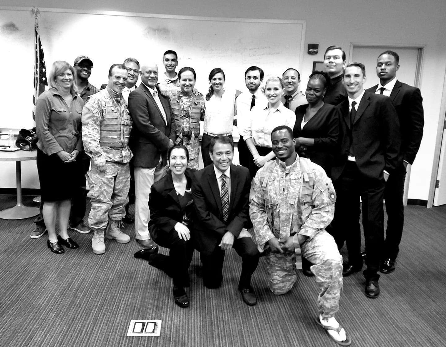 A group photo of diverse professionals in business and casual attire indoors.