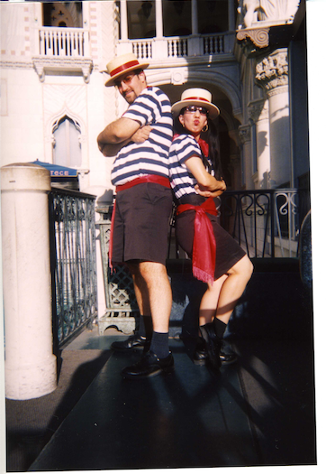 Two stylish people posing confidently on a city street.